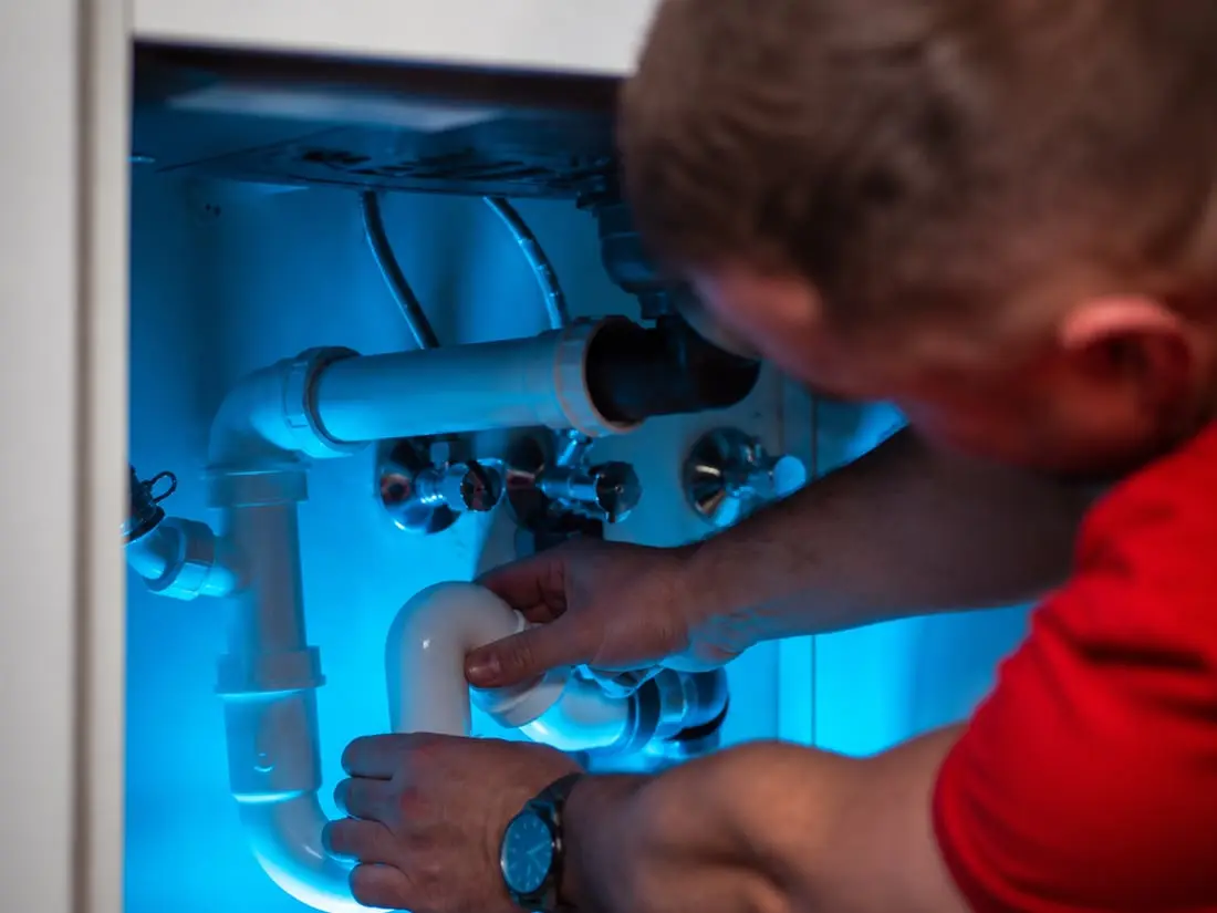 Licensed plumber working on pipe installation in Sarasota FL — Sunrise Contractors